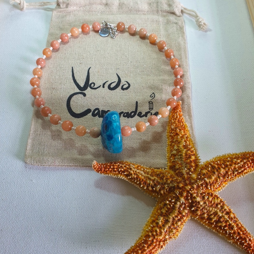 Pink rhodochrosite and blue agate stone with sterling silver clasps and logo..